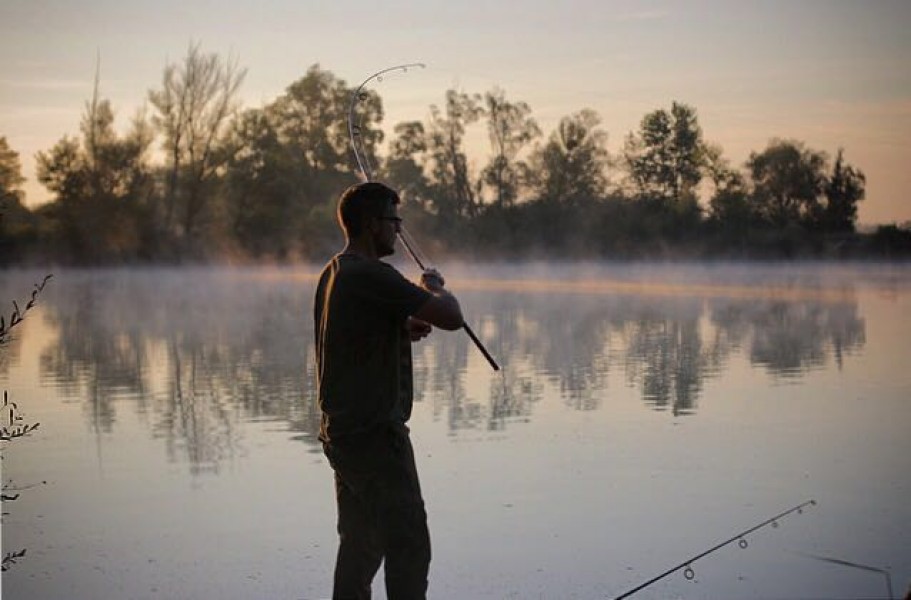 Neil Spooner into a fish in the early morning mist